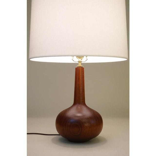 A minimal yet impressive Danish Mid Century Modern solid lathe turned staved Walnut "Genie Bottle" table lamp designed and...