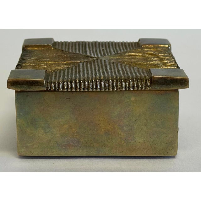 Vintage lidded brass box featuring rounded edges and basketweave treatment on all sides and top. Brass interior. Made by...