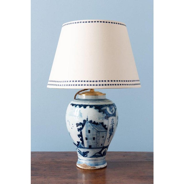 A pair of 18th-century dutch delft vase lamps, each with an elegant baluster form and a narrow upright neck. They are...