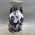 A matched pair of porcelain vases on a crisp white ground, hand-painted in underglaze blue with classic bird-and-flower...