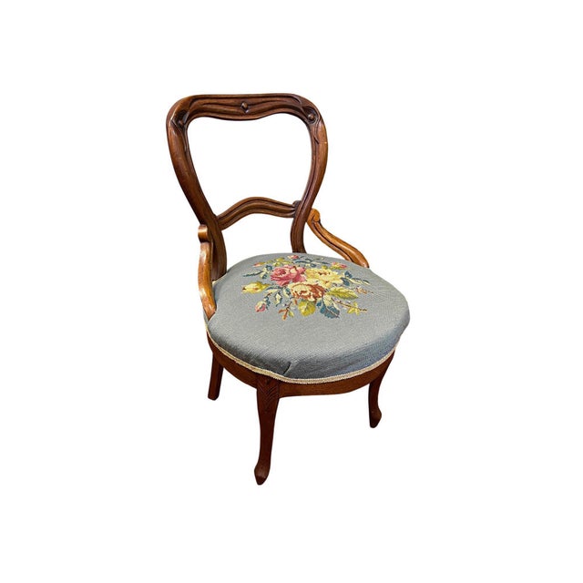 This chair embodies the Victorian Rococo Revival style popular from the 1840s to the 1870s. Crafted from dark...