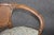 This elegant pair of French Art Nouveau walnut armchairs beautifully captures the organic grace and artistic innovation...