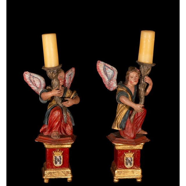 A charming pair of Spanish Baroque angel torchères dating from the 18th century, carved in wood and richly polychromed....