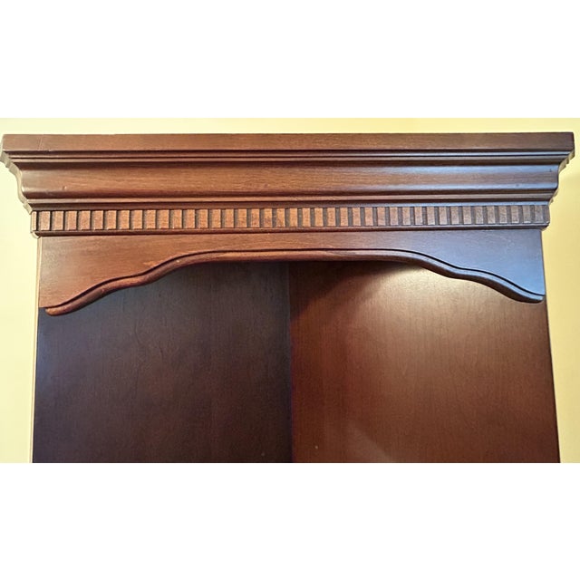 Elevate an underutilized corner with this stately traditional corner cabinet by renowned American manufacturer Hooker...