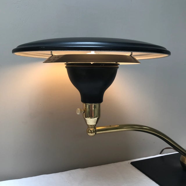 Black and brass “Sight Light” desk lamp designed by Leroy Doane in the 1950s for the M.G. Wheeler Co. The lamp features a...