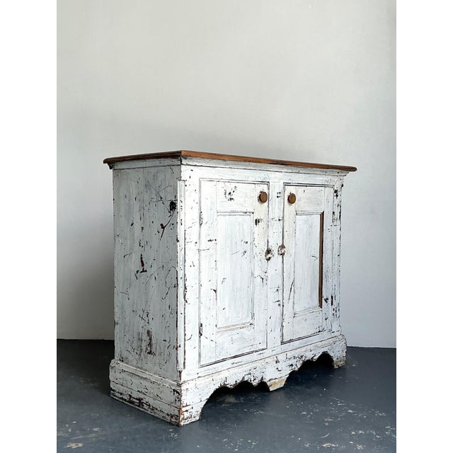 This authentic antique primitive sideboard embodies the quiet beauty and honest craftsmanship of early utilitarian...