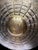 A handmade Turkish brass armor display featuring a domed helmet and round shield mounted on a matching pedestal stand. The...