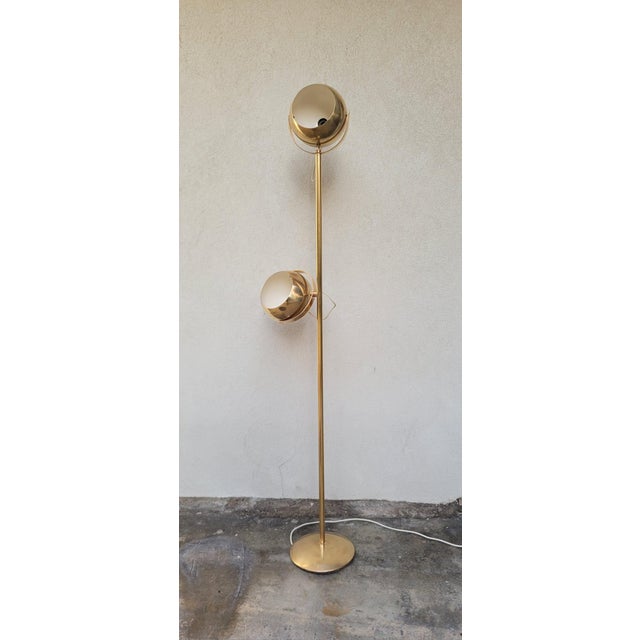 Two-globe brass floor lamp by Goffredo Reggiani, 1960s and 1970s. It features an iconic design with spherical globes that...