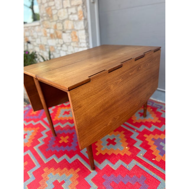 A versatile mid-century modern drop-leaf dining table by Drexel, from the Parallel collection. Beautifully restored walnut...