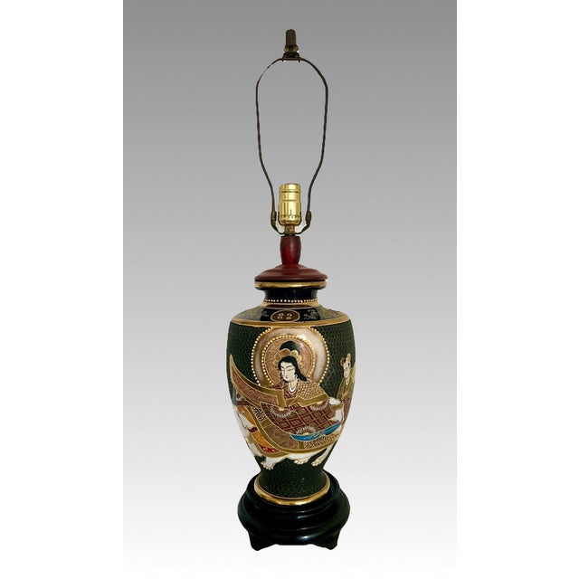 A very striking Japanese Table Lamp featuring traditional Japanese Buddhist figures. Black moriage decoration with raised...
