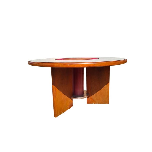 Beautiful circular table in walnut wood, with laminate and steel top, designed by Silvio Coppola for Bernini, a historic...