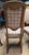 This Pair of Late 19th Century Neoclassical Directoire-Style Walnut Side Chairs With Rosette Mounts is a warm set with...