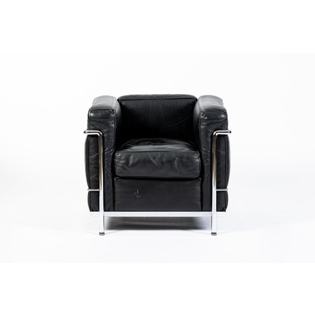 This authentic LC2 Petit Modele black leather armchair originally designed by Le Corbusier, Charlotte Perriand and Pierre...