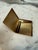 A refined Gucci cigarette case crafted in Italy during the 1970s, featuring a polished gold-plated frame paired with a...