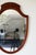 This charming Federal style shield mirror dates to the 1920s - 1940s. The handsome mahogany frame features a gracefully...