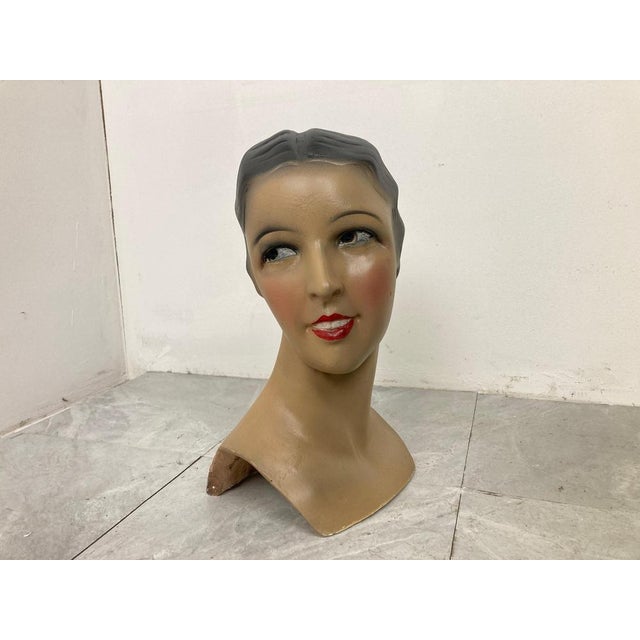 Beautiful female mannequin head made from plaster servings as an advertising bust in a shop. It was used to be displayed...