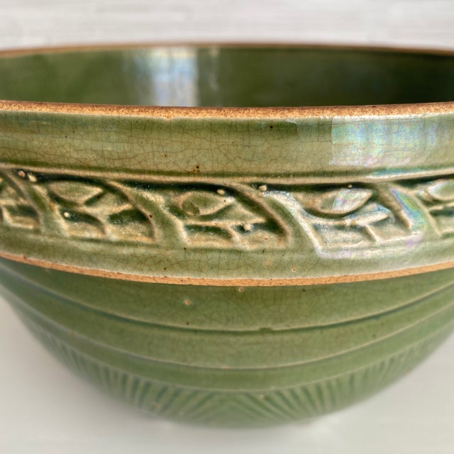 Vintage McCoy sunburst pottery mixing bowl in rare green glaze. A 1920's creation with a distinctive sunburst pattern at...