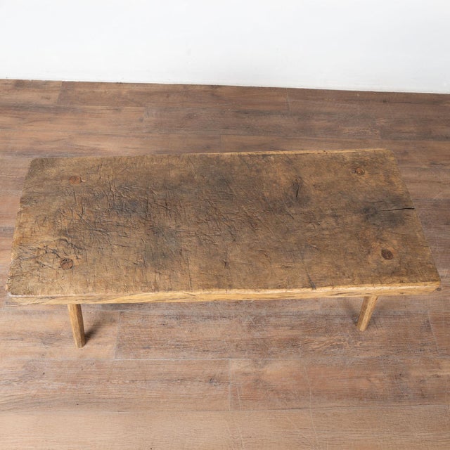 The appeal of this rustic coffee table comes from the thick wood of the top that originally served as a work table, all...