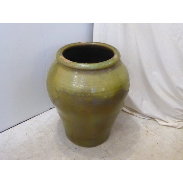 Hand made Spanish storage urn, green glaze overall.