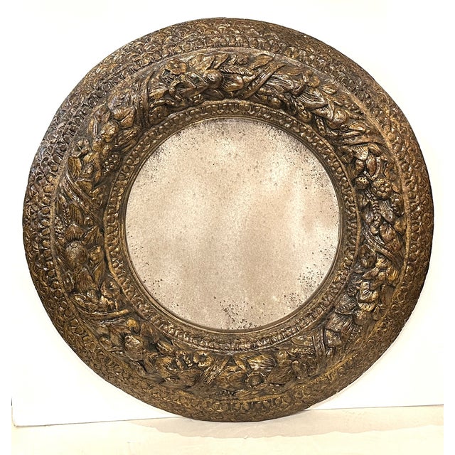 A striking, richly hand carved, gessoed, and gold gilded Italian roundel frame. The whole, intricately carved with a...