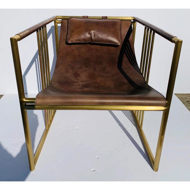 Original retail $8700, Stylish Baker Modern Rustic Brown Vintage Leather Sling Chair, brass finished metal frame, this...