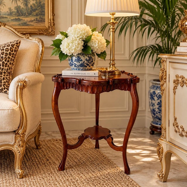 Elegant vintage end table crafted of mahogany wood, featuring a distinctive shaped top with a raised scalloped gallery...