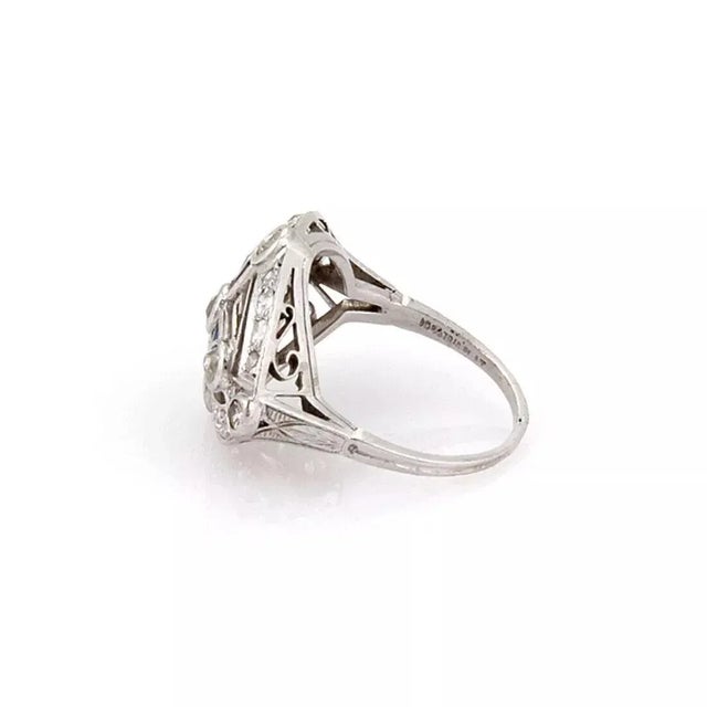 This is a beautiful Art Deco ring, it is crafted from platinum with milgrain finish. The top has a curved marquise shape...