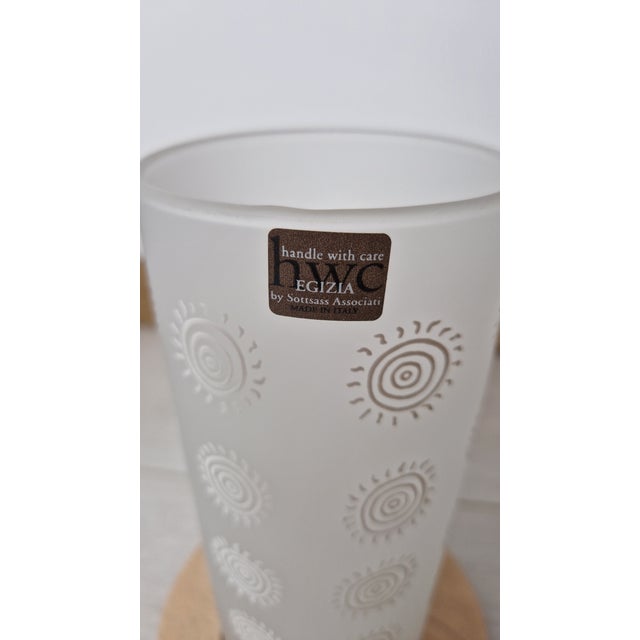 The candle holder is part of the "a collection of decorated glass egizia by sottsass associati" collection, "handle with...