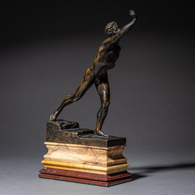 Small bronze sculpture by Max Kruse depicting the Messenger of Marathon, mounted on a profiled marble base in red and...