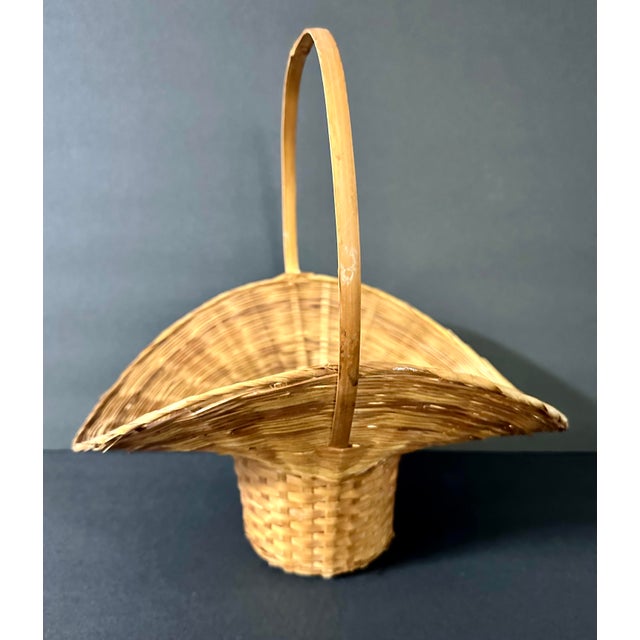 Natural bamboo basket with handle. Approximately 13” x 9” x 14”.