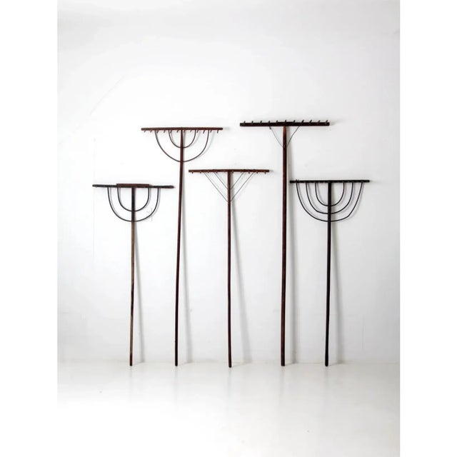 This magnificent collection of five antique primitive hay rakes features variegated sizes and beautifully aged wood that...