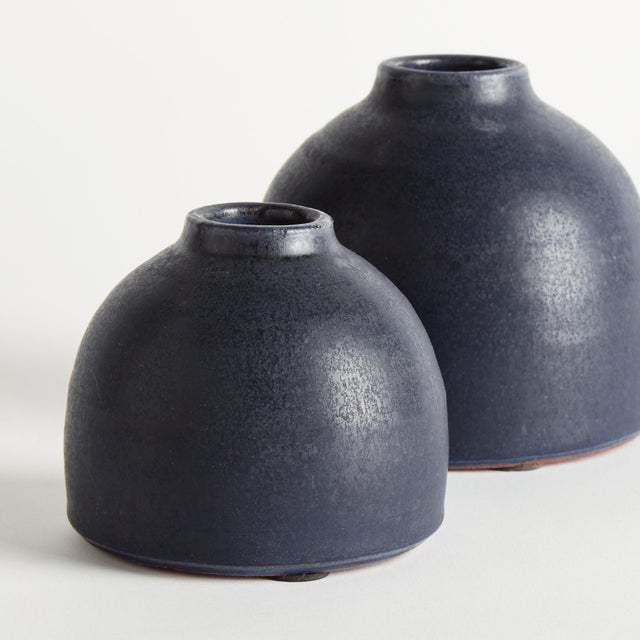With a crackled glaze, uneven texture and basic form, this set of terracotta studio bud vases is simple and raw. In an...