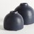 With a crackled glaze, uneven texture and basic form, this set of terracotta studio bud vases is simple and raw. In an...