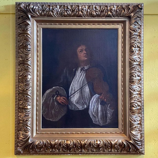 DETAILS An antique, half-length portrait of a gentleman holding a violin. An antique copy after an original artwork by...