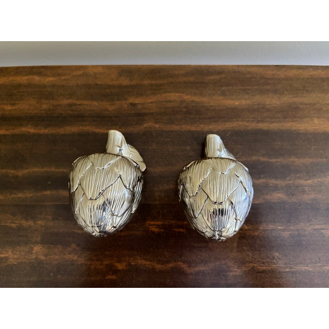 A charming pair of vintage silver-plated artichoke salt and pepper shakers by Godinger, dating to the late 20th century....