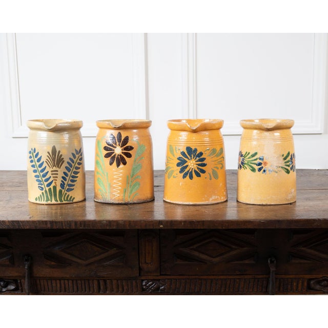 Decorative 19th-century French terracotta pottery pitchers, each displaying the rustic character and individuality of...
