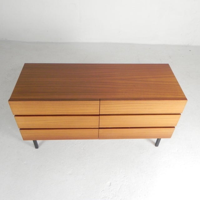 Sleek, practical chest of drawers from the 1960s. The cabinet stands on 4 black square steel legs. There are integrated...