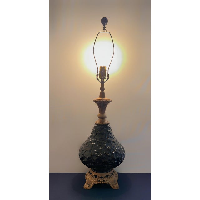 A striking vintage table lamp by Regal Lamp & Shade Co. featuring a sculptural black textured art glass body set on an...
