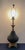 A striking vintage table lamp by Regal Lamp & Shade Co. featuring a sculptural black textured art glass body set on an...