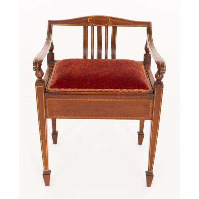 A charming Sheraton Revival mahogany piano stool, combining elegance with functionality It stands on slender tapered legs...