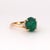 This exquisite 14k yellow gold ring features a captivating cabochon-cut emerald. The emerald weighs 3.33 carats and...