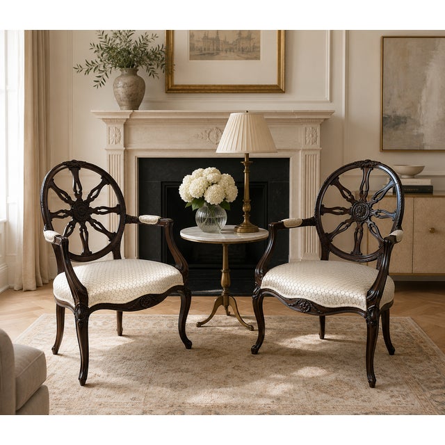 A stylish pair of antique Victorian carved mahogany desk chairs with unusual circular spider web backs, shaped arms and...