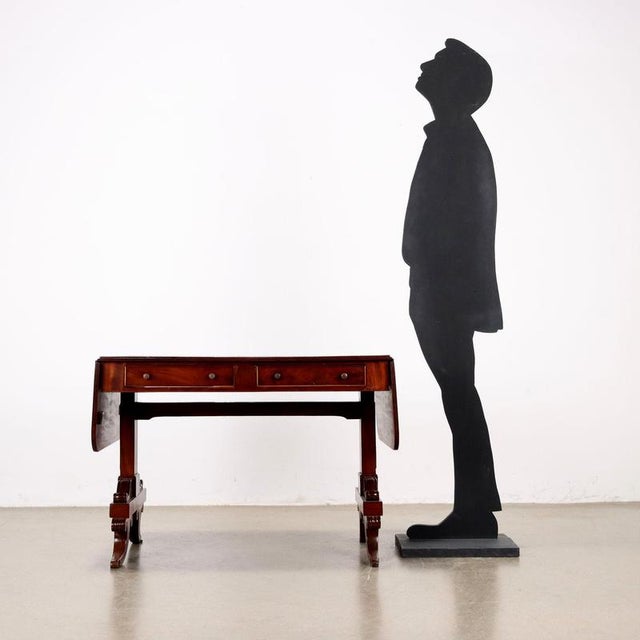 Mahogany hinged writing desk. Pair of drawers in the band below the top, legs with scroll carvings resting on sabre feet,...