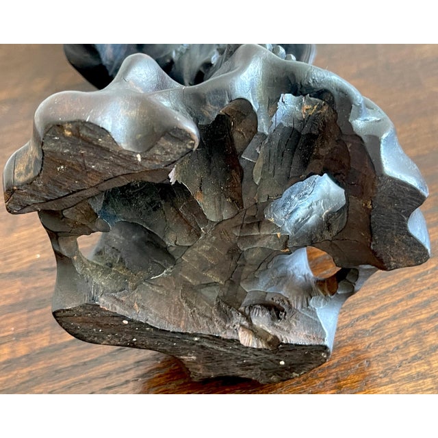 This exquisite late 19th-century Chinese carved hardwood figure depicts an immortal holding a bat, symbolizing happiness...