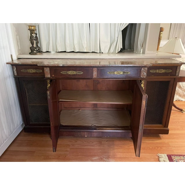 An exceptional late 19th-century French Empire style buffet enfilade, crafted from rich flame mahogany with a stunning...
