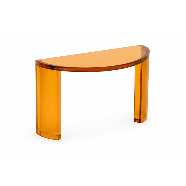 Elevate your space with this striking modern console table, crafted from high-quality transparent amber acrylic...