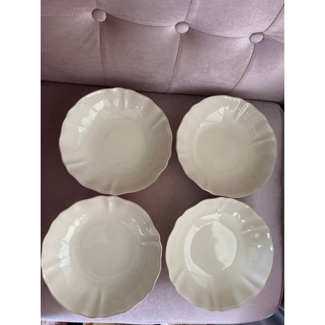 Set of 4 beautiful vintage stoneware serving bowls, made in Portugal. Features an elegant scalloped edge and a soft cream...