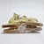 An elegant Italian Art Deco glazed ceramic sculpture depicting a stylized recumbent deer, created by the renowned Fidia...