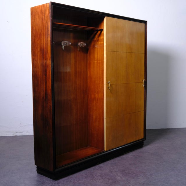 This piece of furniture is an Italian Art Deco-style entryway wardrobe, dating approximately to the 1940s. The piece...