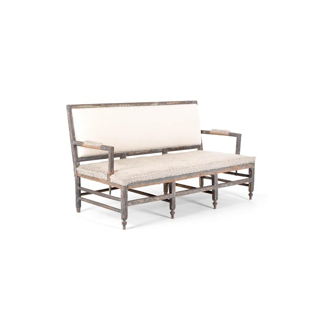 A stunning 19th century sofa or bench settee in a distressed grey painted finish. The sofa has a wide rectangular padded...